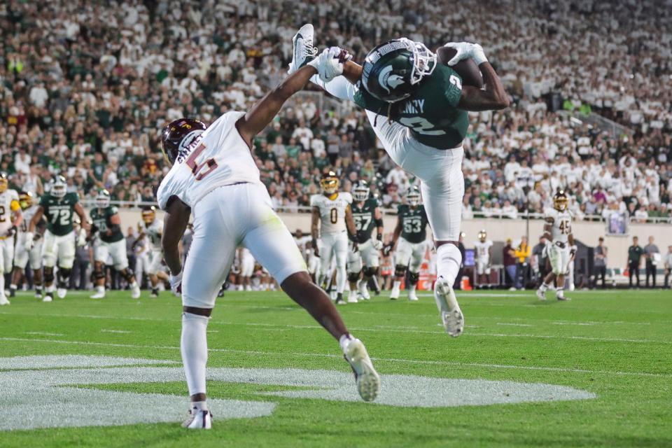 Michigan State wide receiver Tyrell Henry (2) makes a catch for a touchdown against Central Michigan defensive back De'Javion Stepney (5) during the second half at Spartan Stadium in East Lansing on Friday, Sept. 1, 2023.