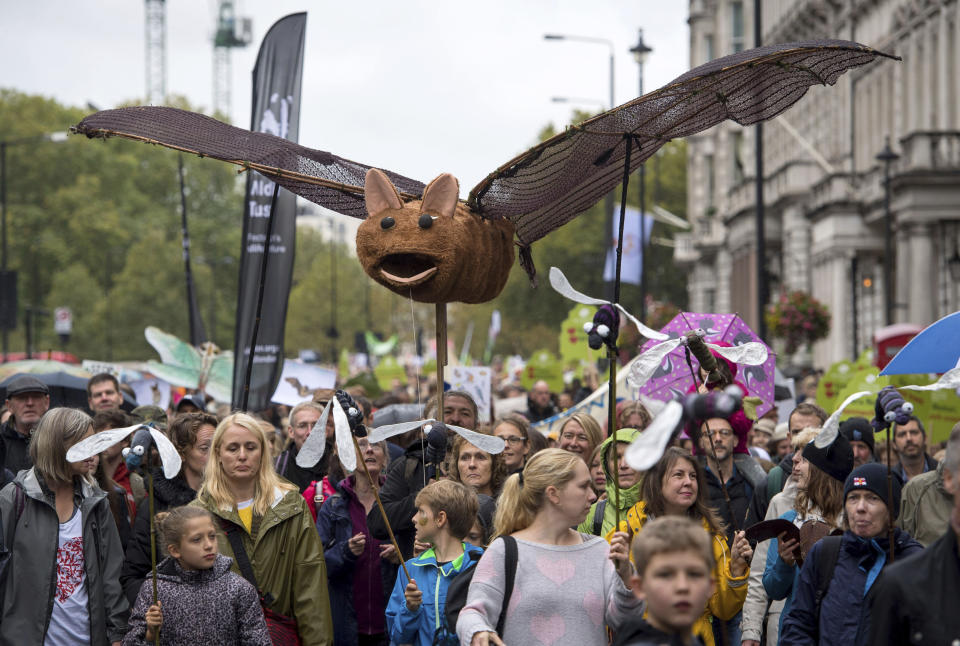 People gather during the People's Walk for Wildlife in central London, Saturday Sept. 22, 2018. Some hundreds of people gathered in London to demand better protection for the country’s wildlife, with many carrying banners in support of various pro-nature and pro-animal causes. (Dominic Lipinski/PA via AP)