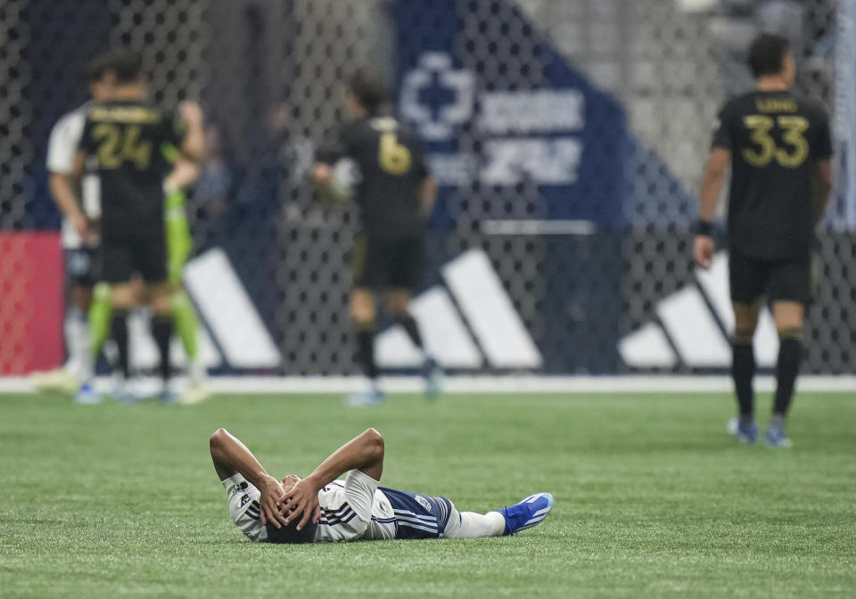 Vancouver Whitecaps' Pedro Vite lies on the field after Los Angeles FC defeated his team in Game 2 of a first-round MLS playoff soccer match in Vancouver, British Columbia, Sunday, Nov. 5, 2023. (Darryl Dyck/The Canadian Press via AP)