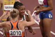 Nafissatou Thiam, of Belgium is greeted by Anouk Vetter, of Netherlands, silver, after winning the gold medal in the heptathlon at the 2020 Summer Olympics, Thursday, Aug. 5, 2021, in Tokyo, Japan. (AP Photo/Charlie Riedel)