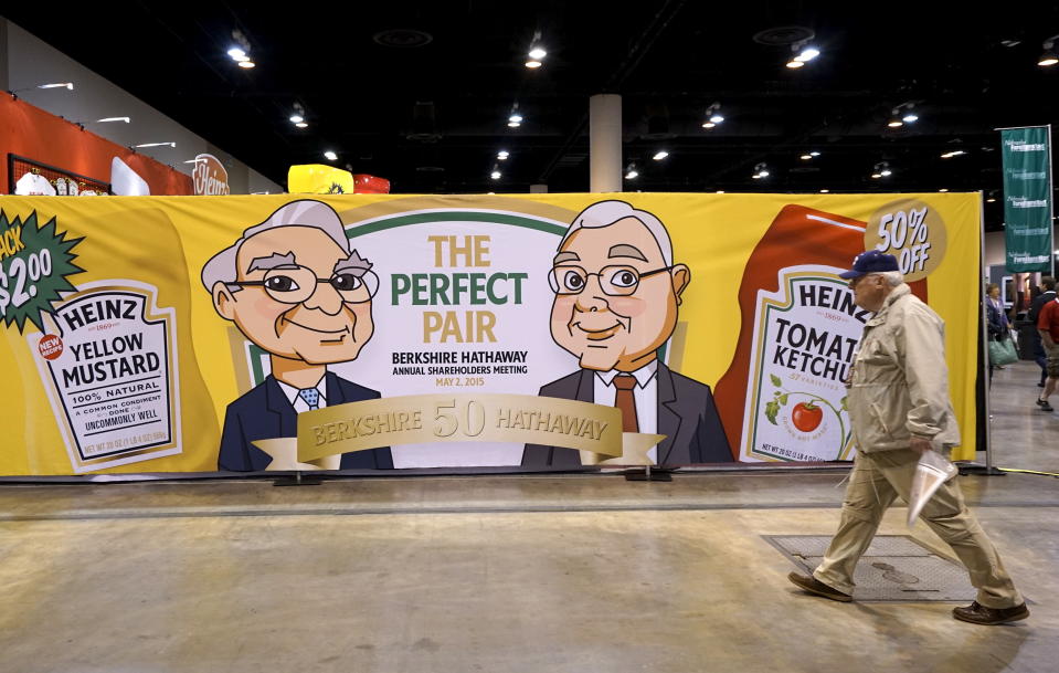 A Berkshire Hathaway shareholder walks by a Heinz company display at the shareholder's shopping day in Omaha, Nebraska May 1, 2015. Berkshire-owned Heinz was selling ketchup and mustard special editon bottles featuring images of Berkshire CEO Warren Buffett and Berkshire vice-chairman Charlie Munger. The annual meeting takes place May 2, 2015. REUTERS/Rick Wilking