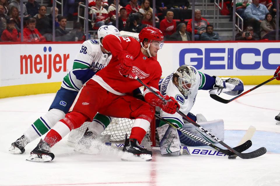 Detroit Red Wings' Michael Rasmussen tries to get a shot off on Vancouver Canucks goalie Jacob Markstrom during the second period at Little Caesars Arena on Nov. 6, 2018 in Detroit.