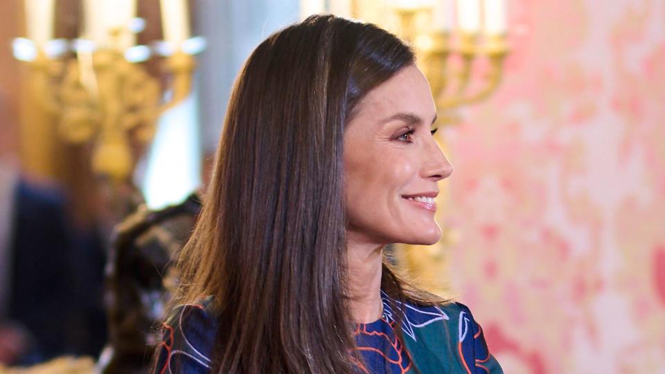 Queen Letizia smiling to the side in floral dress