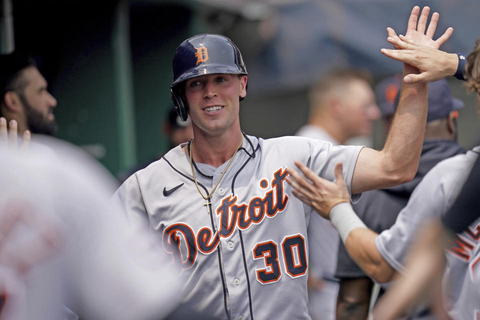 Teammates congratulate Detroit Tigers' Kerry Carpenter after he scored on a single by Javier Baez against the Pittsburgh Pirates in the fourth inning of a baseball game in Pittsburgh, Wednesday, Aug. 2, 2023. (AP Photo/Matt Freed)