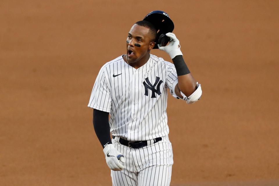 New York Yankees Miguel Andujar removes his cap after flying out to left field with two runners on base during the first inning of a baseball game against the Boston Red Sox, Monday, Aug. 17, 2020, in New York .  (AP Photo/Kathy Willens)
