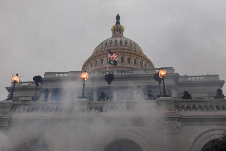 Clouds of tear gas billow around the balcony in front of the U.S. Capitol.