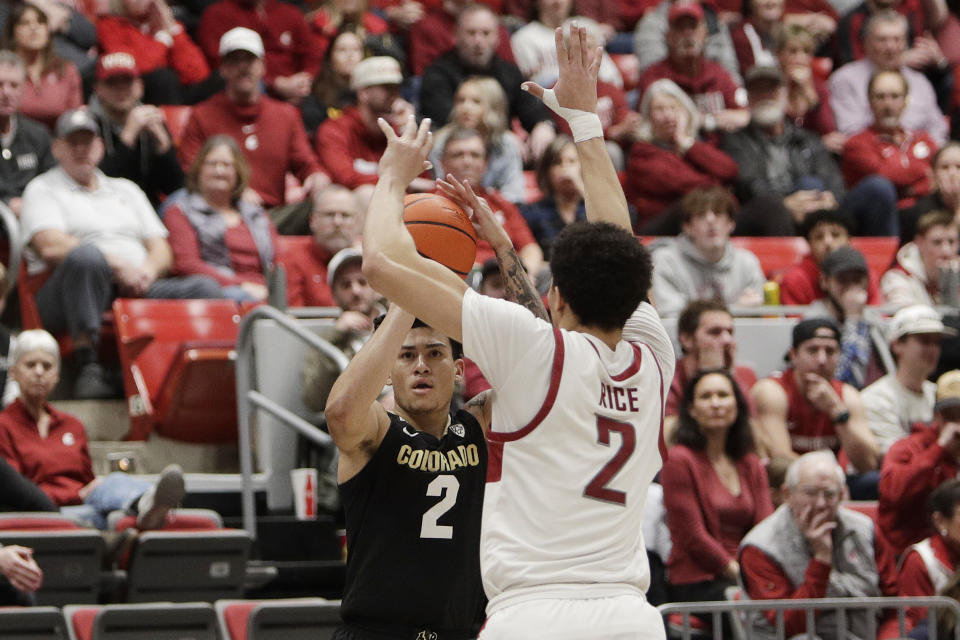 Colorado guard KJ Simpson, left, prepares to shoot while pressured by Washington State guard Myles Rice during the second half of an NCAA college basketball game, Saturday, Jan. 27, 2024, in Pullman, Wash. Washington State won 78-69. (AP Photo/Young Kwak)