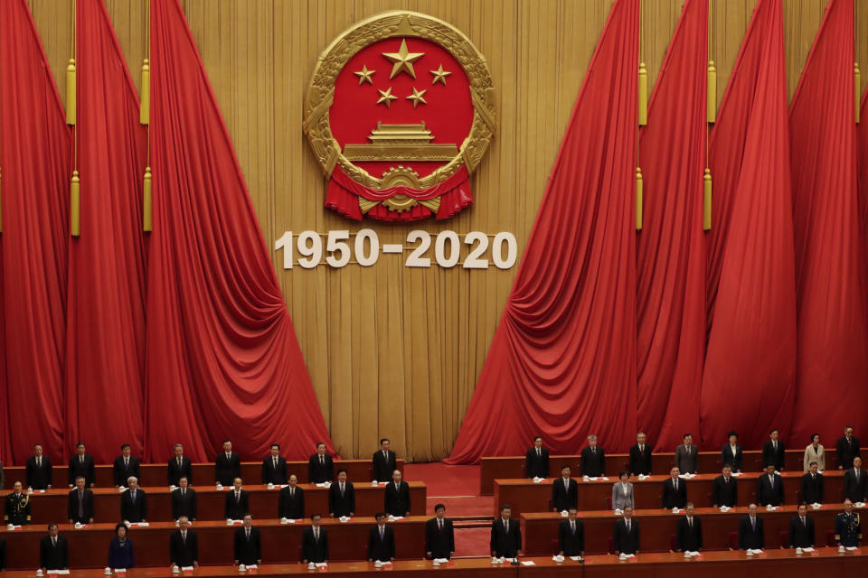 Chinese President Xi Jinping, bottom center, and high ranking officials stand for the national anthem during the commemorating conference on the 70th anniversary of China’s entry into the 1950-53 Korean War, at the Great Hall fo the People in Beijing, Friday, Oct. 23, 2020. (AP Photo/Andy Wong)