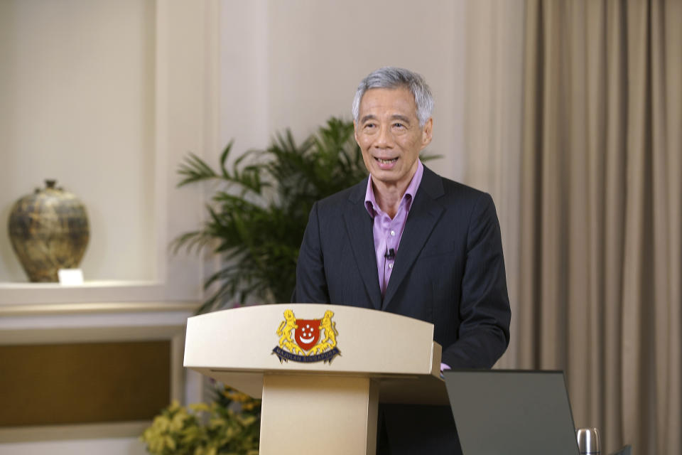 In this photo provided by the Singapore Ministry of Communications and Information, Prime Minister Lee Hsien Loong addresses the nation with updates on the COVID-19 situation in the city state Monday, May 31, 2021, in Singapore. Lee said controls to lower coronavirus infections were working, while announcing a move to vaccinate students after a spate of transmissions in schools and learning centers. (Ministry of Communications and Information via AP)