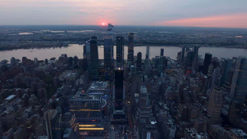 The sun is shrouded as it sets behind Hudson Yards as smoke from forest fires in Alberta, Canada drifts into the northeast US seen from the Empire State Building on May 9, 2023, in New York City.  Photo by Gary Hershorn/Getty Images - Gary Hershorn/Corbis News/Getty Images