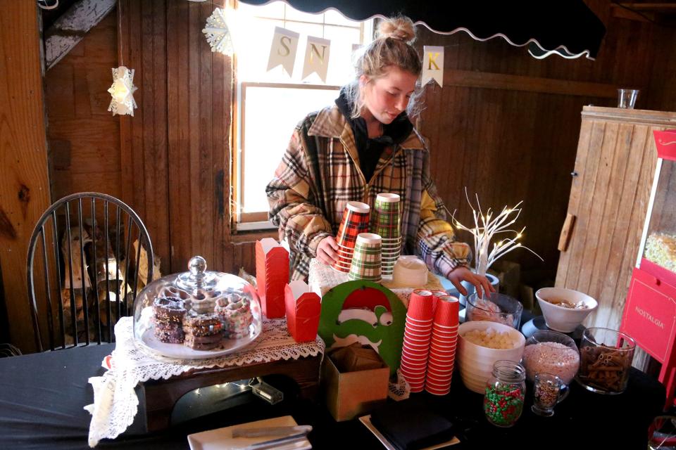 Kam Huff works at the complimentary hot chocolate bar at the Captains Collection.