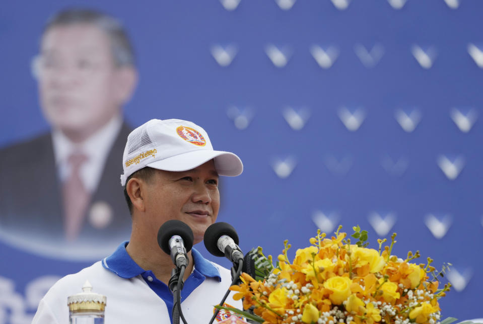 Hun Manet, front right, a son of Cambodia Prime Minister Hun Sen, delivers a speech before leading a procession to mark the end of an election campaign of Cambodian People's Party, in Phnom Penh, Cambodia, Friday, July 21, 2023. Hun Sen says he is ready to hand the premiership to his oldest son, Hun Manet, who heads the country’s army. (AP Photo/Heng Sinith)