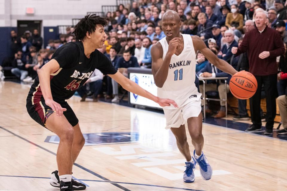 Franklin senior Hansy Jacques works to get past BC High sophomore Jalen Rogers during the Division 1 Elite 8 game at Franklin High, March 9, 2024. The Panthers beat the Eagles, 66-49.