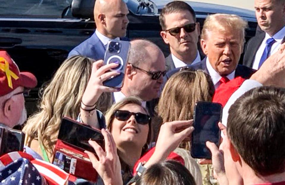 Former U.S. President Donald Trump arrives and talks with supporters at the Greenville-Spartanburg Airport, in Greer Tuesday, February 23, 2024. Trump got in a motorcade to Greenville Convention Center for a videotaping of The Ingram Angle with host Laura Ingram at the Greenville Convention Center in Greenville, S.C.
