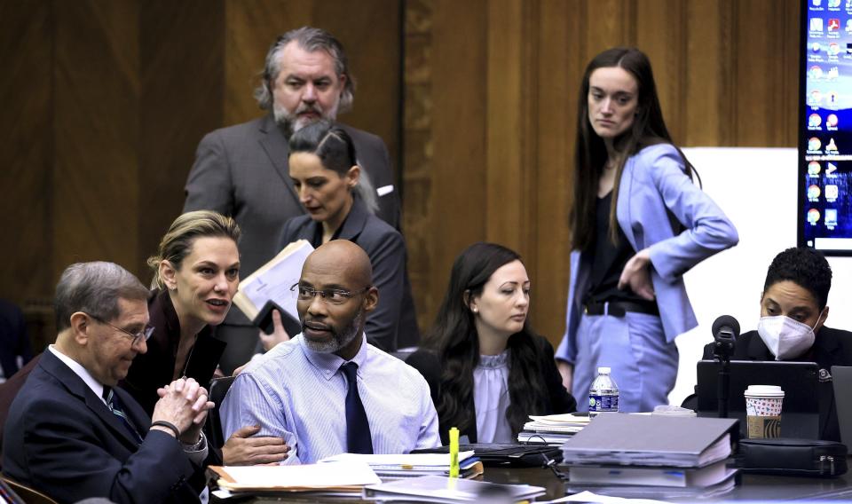 Lamar Johnson, third from the left, is surrounded by his lawyers as he takes a seat in court at the start of his wrongful conviction hearing in St. Louis on Monday, Dec. 12, 2022. (David Carson/St. Louis Post-Dispatch via AP, Pool)