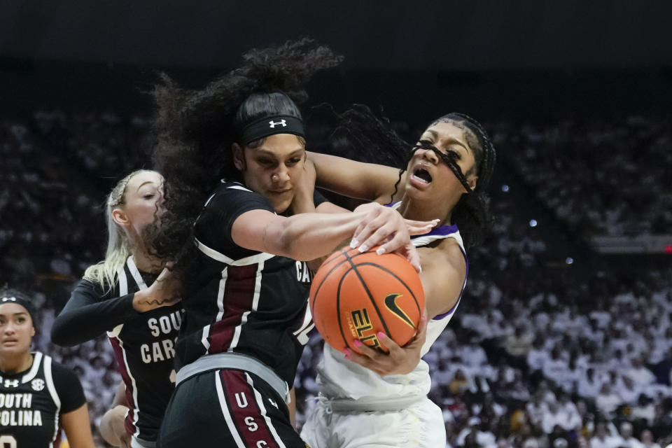 LSU forward Angel Reese, right, and South Carolina center Kamilla Cardoso battle under the basket in the first half an NCAA college basketball game in Baton Rouge, La., Thursday, Jan. 25, 2024. (AP Photo/Gerald Herbert)