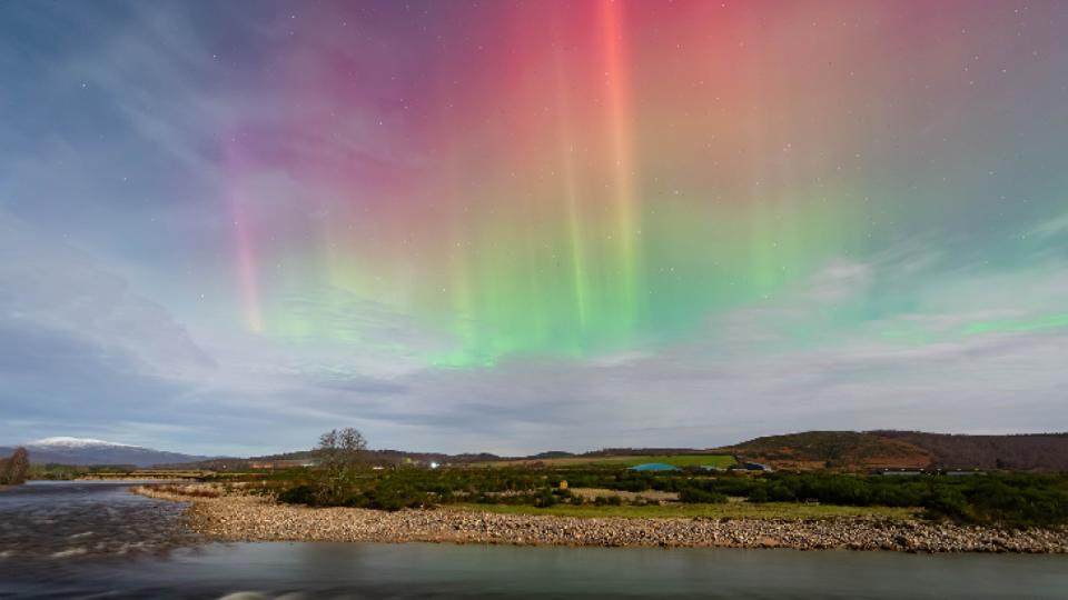 Red, orange and green auroras in the night sky