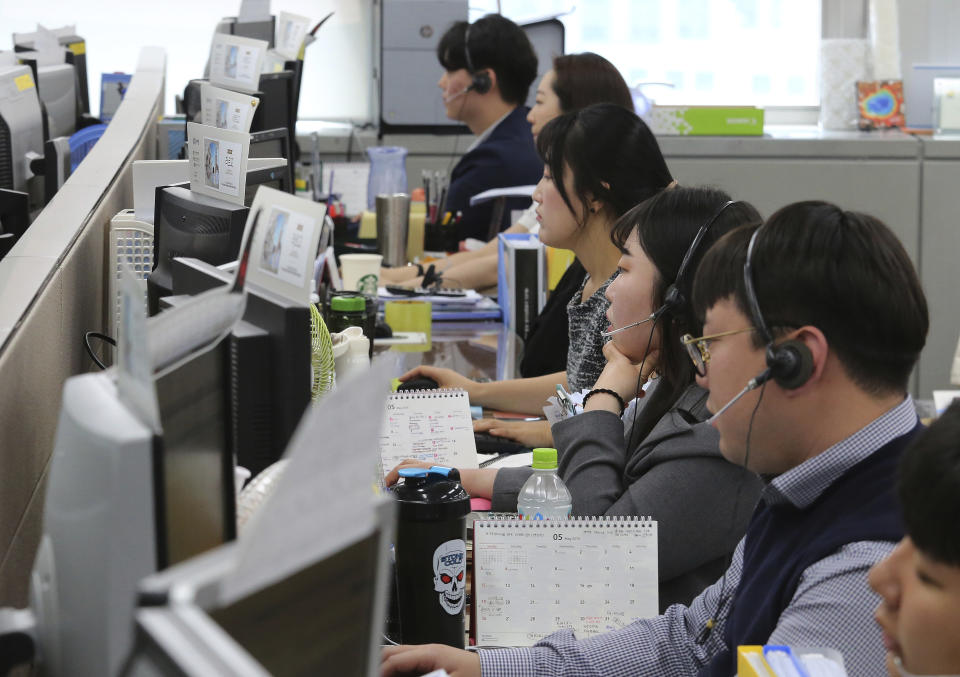 Employees of Very Good Tour Co. talk on the phones at its headquarters in Seoul, South Korea, Thursday, May 30, 2019. A sightseeing boat carrying 33 South Korean passengers and two crew members collided with another vessel and sank in the Danube River in downtown Budapest. The tourists are confirmed to have been on a package tour to Hungary sold by the travel agency. (AP Photo/Ahn Young-joon)