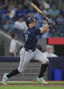 Seattle Mariners catcher Cal Raleigh (29) hits the game winning two run home run during the tenth inning of a baseball game against the Toronto Blue Jays in Toronto on Wednesday, April 10, 2024. (Nathan Denette/The Canadian Press via AP)