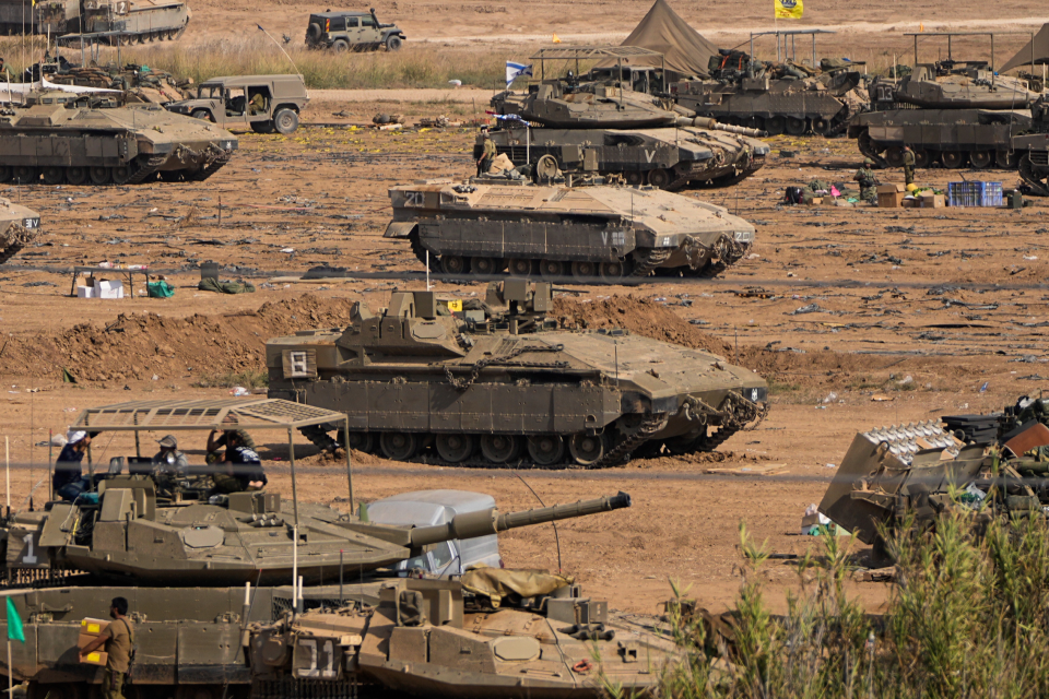 Israeli soldiers gather in a staging area near the border with Gaza Strip (AP)