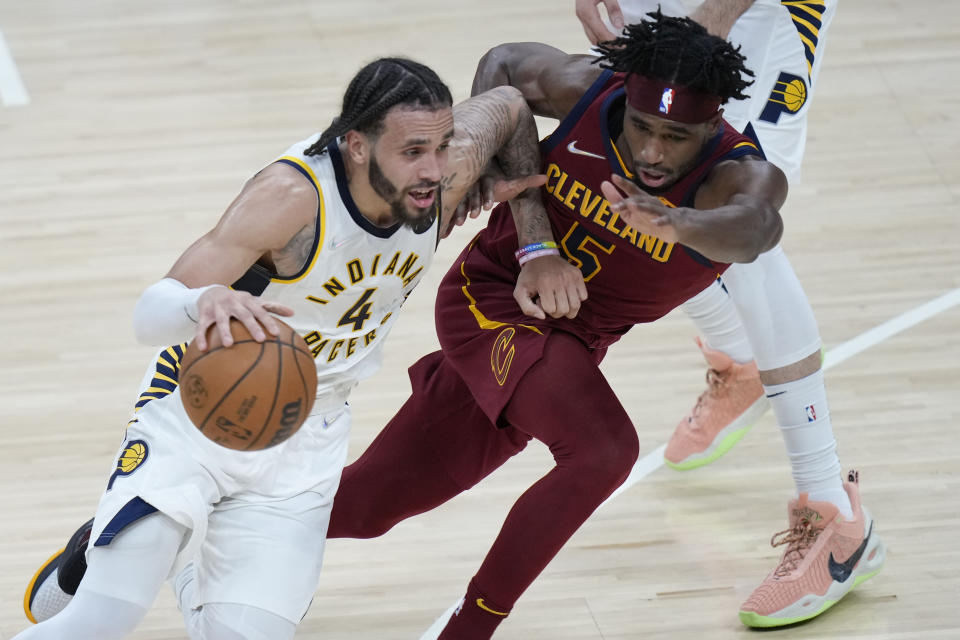 Indiana Pacers guard Duane Washington Jr. (4) drives around Cleveland Cavaliers guard RJ Nembhard Jr. during the second half of an NBA preseason basketball game in Indianapolis, Friday, Oct. 15, 2021. The Cavaliers won 110-94. (AP Photo/AJ Mast)