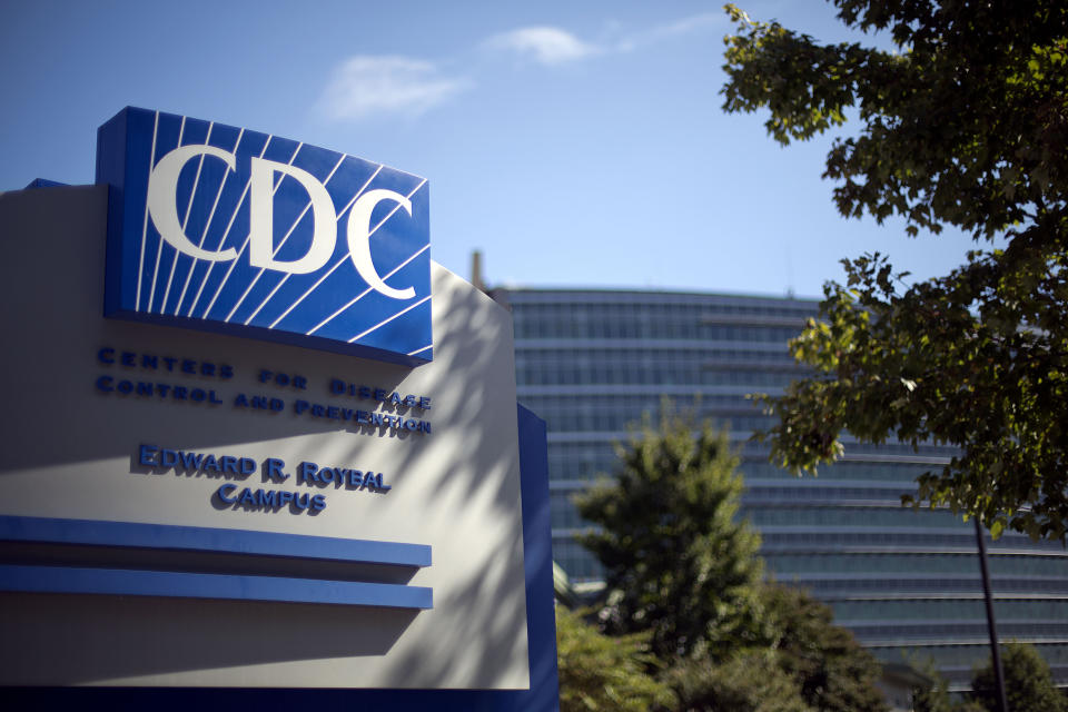 FILE - In this Oct. 8, 2013, file photo, a sign marks the entrance to the federal Centers for Disease Control and Prevention in Atlanta. In the United States, the nation with the most pandemic deaths, the reporting of vital coronavirus case and testing data is not keeping pace with its speedy spread. Public health officials nationwide lean too heavily on faxes, email and spreadsheets, sluggish and inefficient 20th-century tools. (AP Photo/David Goldman, File)