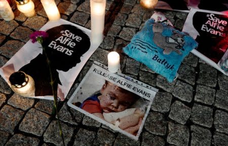 Candles and placards are pictured during a protest in support of Alfie Evans, in front of the British Embassy building in Warsaw, Poland April 26, 2018. REUTERS/Kacper Pempel