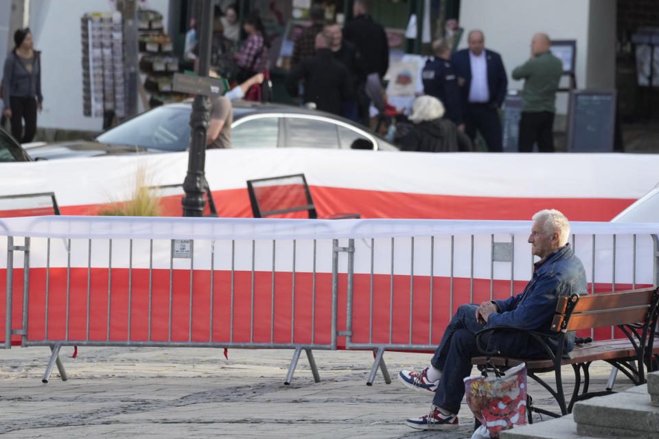 A man waits for the final election campaign rally of ruling PiS (Law and Justice) leader Jaroslaw Kaczynski, in Sandomierz, Poland, Friday, Oct. 13, 2023. At stake in Sunday's vote are the health of the nation's democracy, strained under the ruling conservative Law and Justice party, and the foreign alliances of a country on NATO's eastern flank that has been a crucial ally. The main challenger is centrist Civic Coalition. (AP Photo/Czarek Sokolowski)