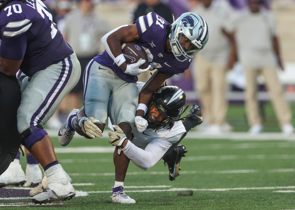 Kansas State running back DJ Giddens, top, breaks the tackle of Central Florida's Tre'Mon Morris-Brash during last Saturday's game at Bill Snyder Family Stadium.