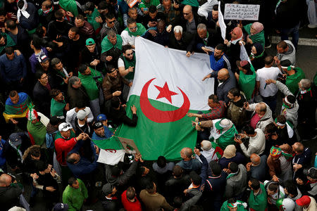 FILE PHOTO: Demonstrators hold flags and banners as they return to the streets to press demands for wholesale democratic change well beyond former president Abdelaziz Bouteflika's resignation in Algiers, Algeria April 19, 2019. REUTERS/Ramzi Boudina should/File Photo
