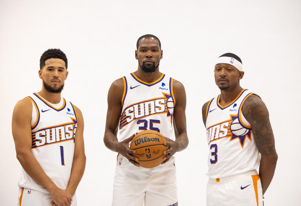 Phoenix Suns guard Devin Booker (L), forward Kevin Durant and guard Bradley Beal pose for a portrait during media day at Footprint Center in Phoenix on Oct. 2, 2023. (Mark J. Rebilas/USA TODAY Sports)