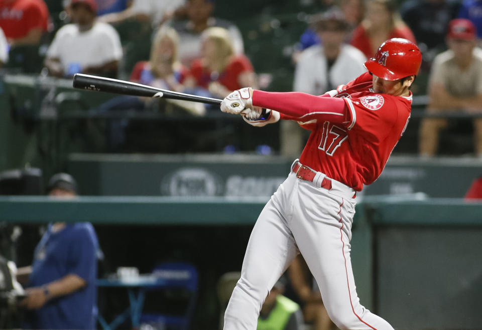 Los Angeles Angels' Shohei Ohtani follows through on a two-run home run against the Texas Rangers during the eighth inning of a baseball game Wednesday Sept. 5, 2018, in Arlington, Texas. (AP Photo/Ray Carlin)