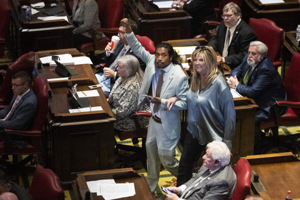 Rep. Justin Jones, D-Nashville, walks into the House chamber with Rep. Gloria Johnson, D-Knoxville, Monday, April 10, 2023, in Nashville, Tenn. Jones was appointed to represent District 52 by the Metro Nashville City Council earlier in the day after being expelled the previous week for using a bullhorn to shout support for pro-gun control protesters in the House chamber. (AP Photo/George Walker IV)