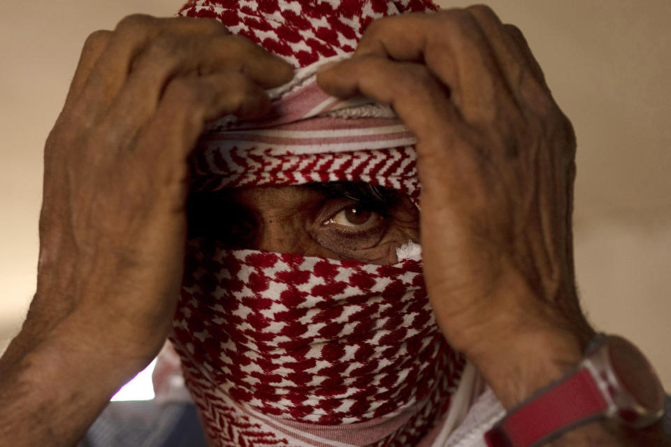 Ahmed, a Palestinian shepherd, poses for a portrait in a hamlet in the South Hebron Hills, Friday, May 17, 2024. Ahmed spoke to AP on condition that only his first name be used, over fear of retaliation. He and other Palestinians in the West Bank say they face harassment and intimidation by Israeli settlers, some of whom have been sanctioned internationally. (AP Photo/Maya Alleruzzo)