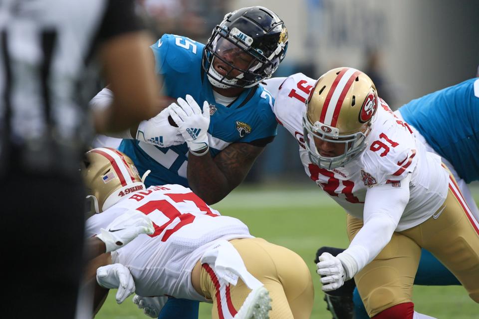 Jacksonville Jaguars running back James Robinson (25) is tackled by San Francisco 49ers defensive end Nick Bosa (97) and defensive end Arik Armstead (91) during the second quarter at TIAA Bank Field Sunday, Nov. 21, 2021 in Jacksonville. The Jacksonville Jaguars hosted the San Francisco 49ers during a regular season NFL game. [Corey Perrine/Florida Times-Union]