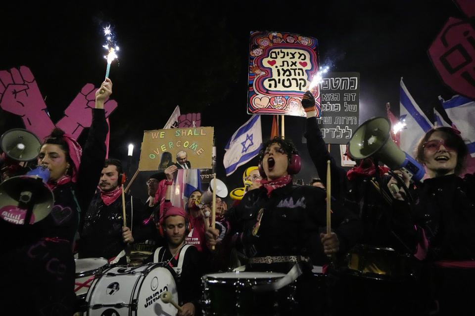 Israelis protest plans by Prime Minister Benjamin Netanyahu's new government to overhaul the judicial system, in Tel Aviv, Israel, Saturday, Feb. 25, 2023. On Tuesday, Netanyahu's government for the first time advanced the plan by securing a preliminary vote at the Knesset, defying a mass uproar among Israelis and calls for restraint from the United States. (AP Photo/ Ariel Schalit)