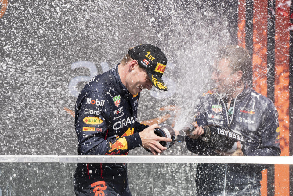 Red Bull driver Max Verstappen, of the Netherlands, is sprayed with champagne by a member of his team after winning the Canadian Grand Prix in Montreal on Sunday, June 19, 2022. (Paul Chiasson/The Canadian Press via AP)