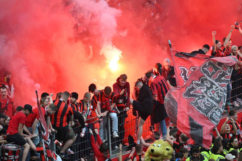 Leverkusen fans set off pyrotechnics during the German Bundesliga soccer match between Bayer 04 Leverkusen and SV Werder Bremen at BayArena. David Inderlied/dpa