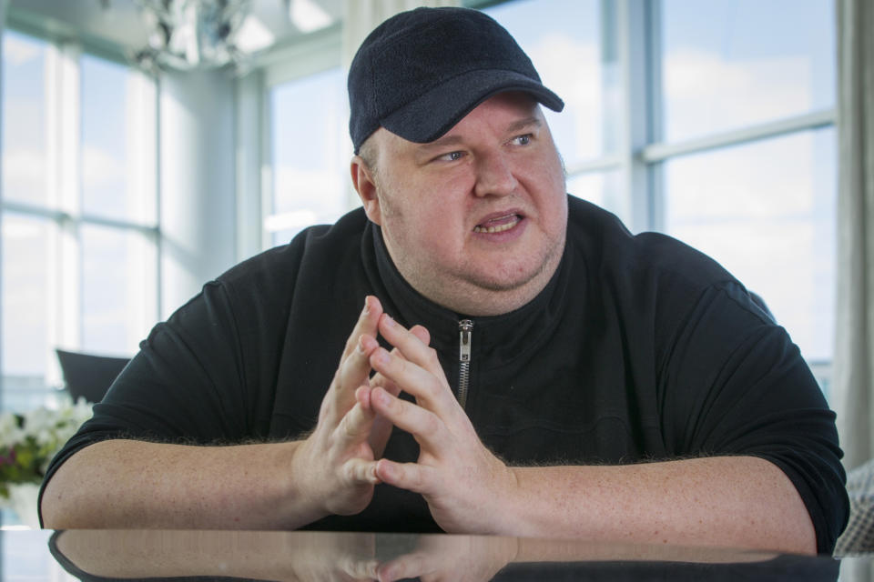 Megaupload founder Kim Dotcom gestures during an interview at his home in Auckland New Zealand, Dec. 21, 2015. Two men charged by U.S. prosecutors with racketeering for their involvement in the once wildly popular file-sharing website Megaupload said Tuesday, May 10, 2022, that they have reached a deal to avoid extradition to the U.S. and will instead face charges in New Zealand, where they live. Dotcom, who also lives in New Zealand, still faces the possibility of extradition to the U.S. in the long-running case. (Greg Bowker/New Zealand Herald via AP)