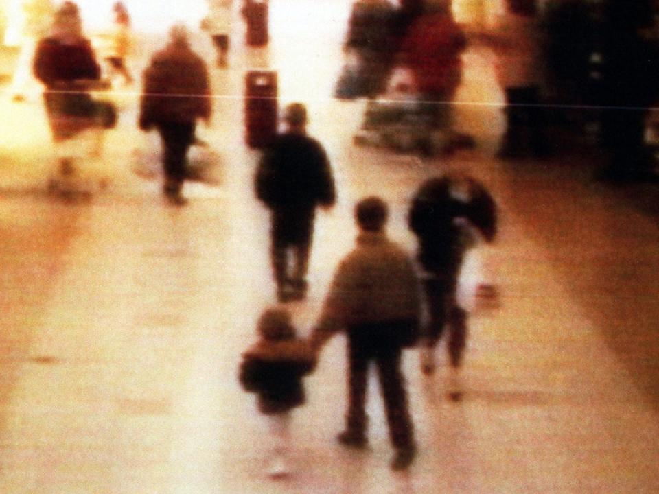 James Bulger is led away from his family on this CCTV shot