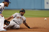 San Francisco Giants' LaMonte Wade Jr., right, steals third base next to Los Angeles Dodgers third baseman Justin Turner during the first inning of a baseball game Thursday, July 22, 2021, in Los Angeles. (AP Photo/Marcio Jose Sanchez)
