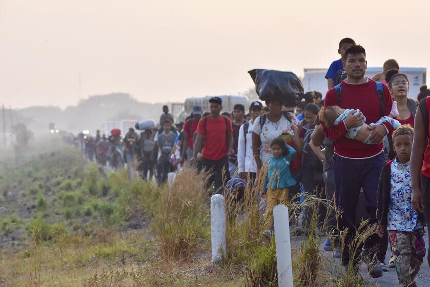 Migrants walk along the highway through Arriaga, Chiapas state in southern Mexico, early Monday, Jan. 8, 2024, during their journey north toward the U.S. border. (AP Photo/Edgar H. Clemente)