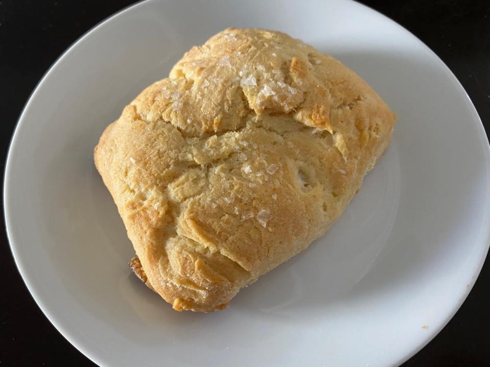 A large biscuit on a white plate.