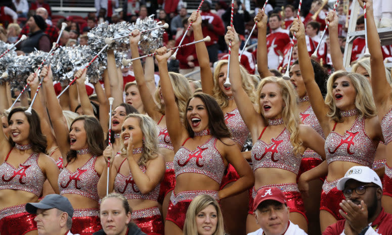 Alabama cheerleaders performing during a football game.