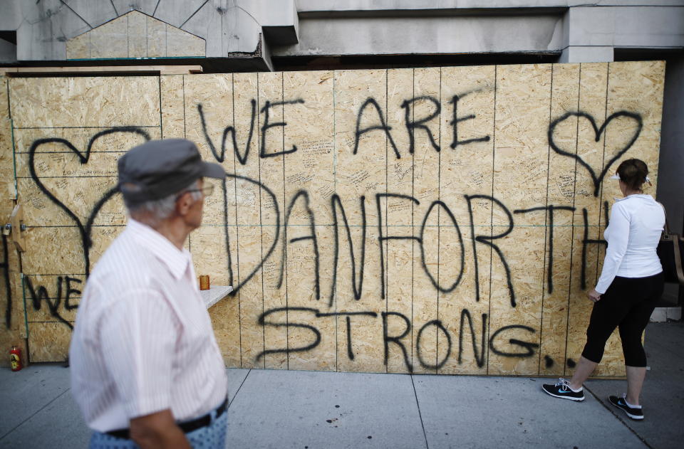 <p>People leave personal messages on a building under renovation, remembering the victims of Sunday’s shooting on and near Danforth Avenue in Toronto on Monday, July 23, 2018. (Photo: Mark Blinch/The Canadian Press via AP) </p>