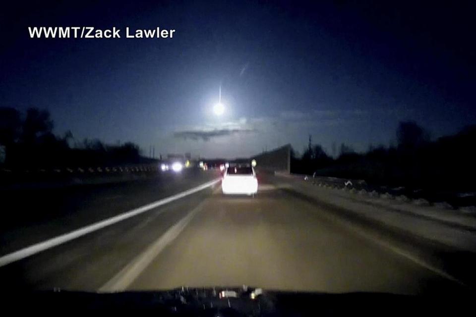 A dash cam video shows a brightly-lit object fall from the sky above the highway. (AP)