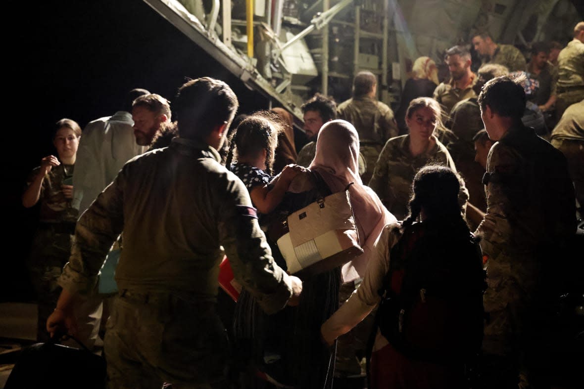 In this photo released by the UK Ministry of Defence the last evacuees and military personnel board an RAF aircraft bound for Cyprus from Wadi Seidna Air Base in Sudan, April 29, 2023. (PO Phot Arron Hoare/Uk Ministry of Defence via AP)