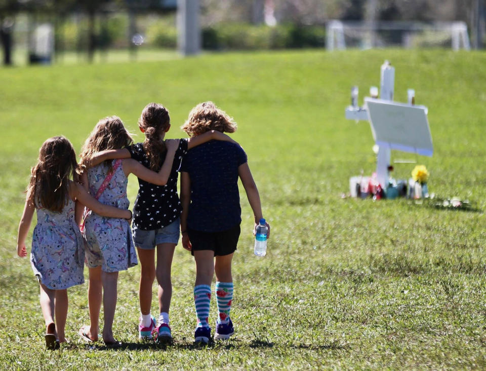 <p>This photo taken Friday, Feb. 16, 2018, shows Four young children with hands around each other as they approach a vigil post at Park Trails Park in Parkland, Fla., on Feb. 16, 2018. (Photo: C.M. Guerrero/The Miami Herald via AP) </p>