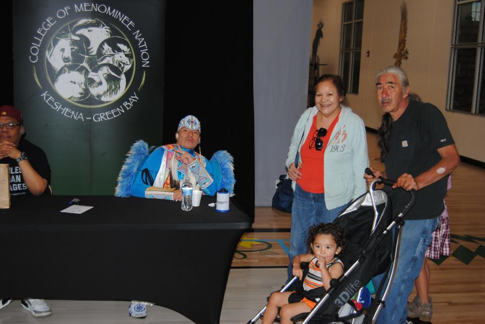 Indigenous hip-hop star Supaman signs autographs during a meet-and-greet with fans on the Menominee Reservation.