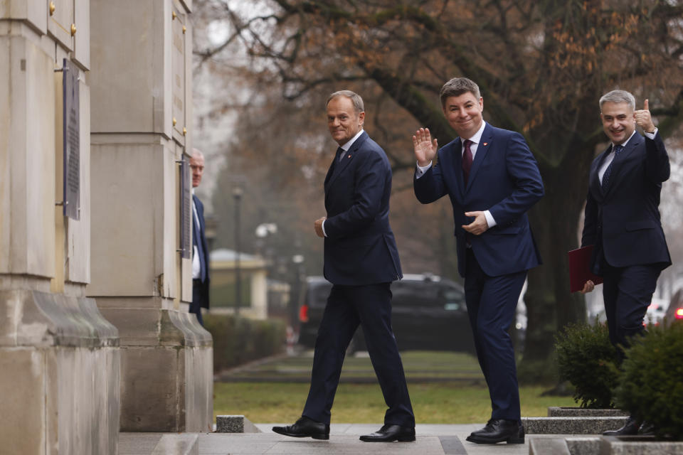 The new Polish Prime Minister Donald Tusk, left, Jan Grabiec, chief of staff, center, and newly appointed Minister of Digital Affairs Krzysztof Gawkowski, arrive at the Prime Minister's office in Warsaw, Poland, Wednesday, Dec. 13, 2023. (AP Photo/Michal Dyjuk)